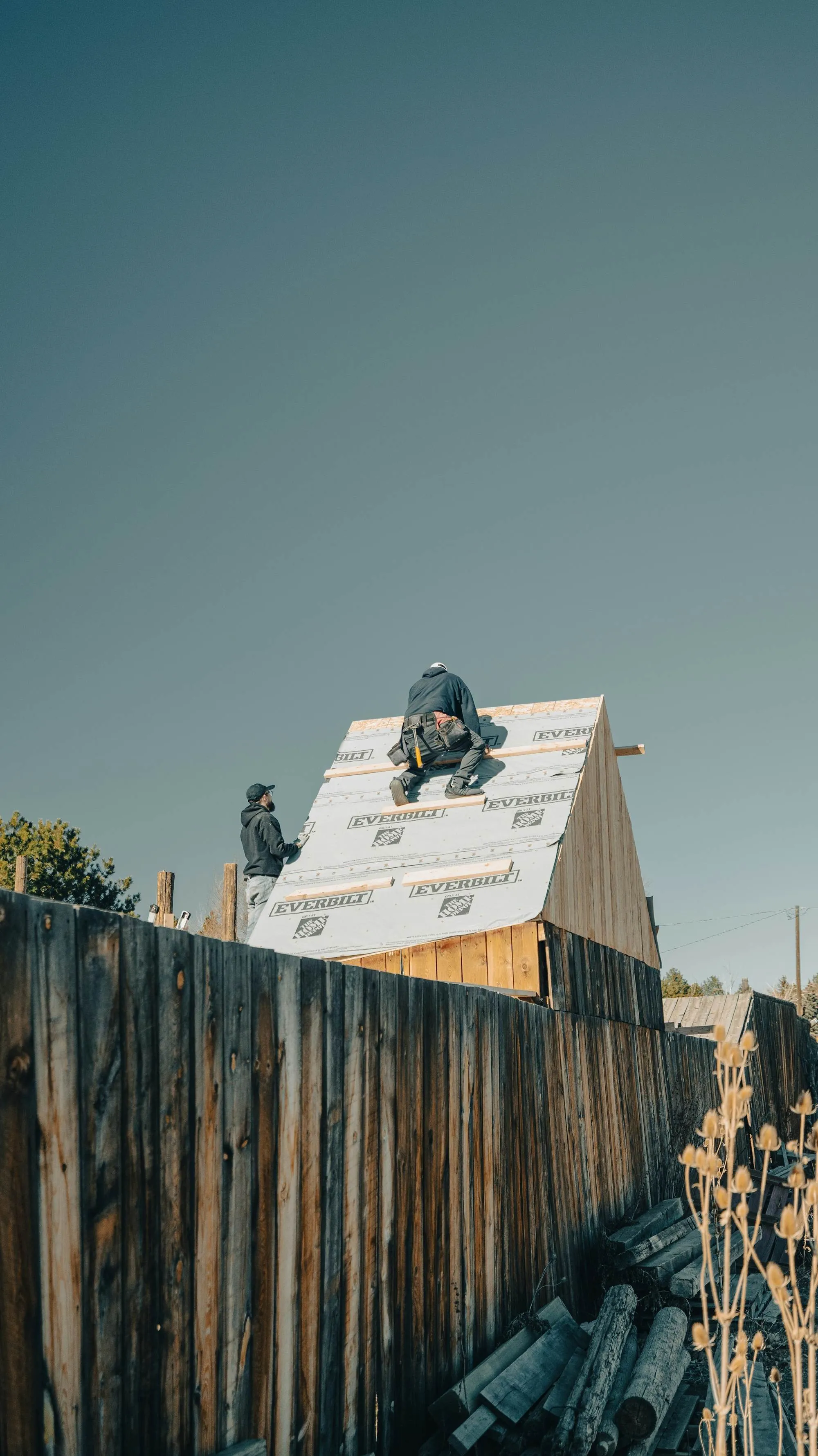 Framing a roof under a clear sky
